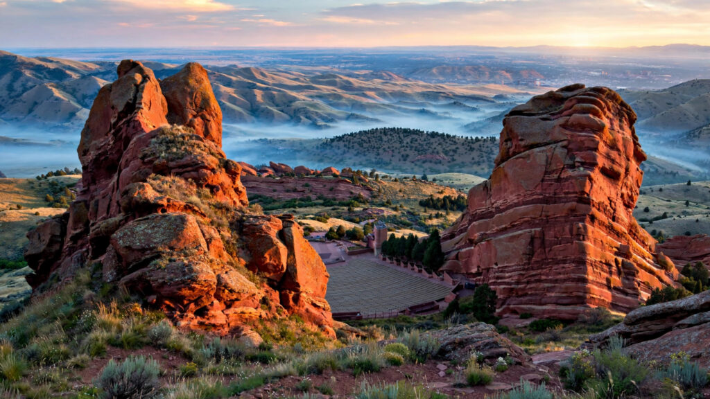 Red Rocks amphitheatre formations with the Denver foothills behind at sunrise.